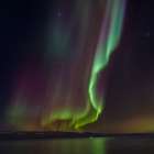 Iceland. Northern Lights over fjord Isafjardardjup near Isafjordur view towards Hornstrandir. Art Print